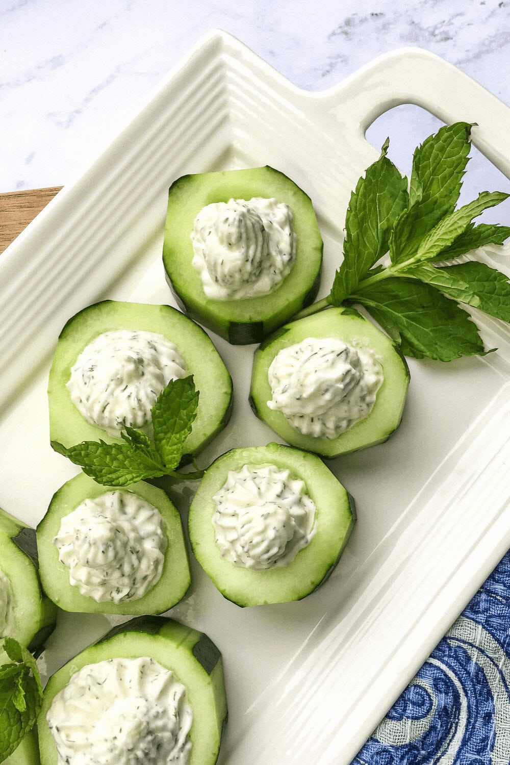A closeup of Whipped Feta Cucumber Cups on a serving dish