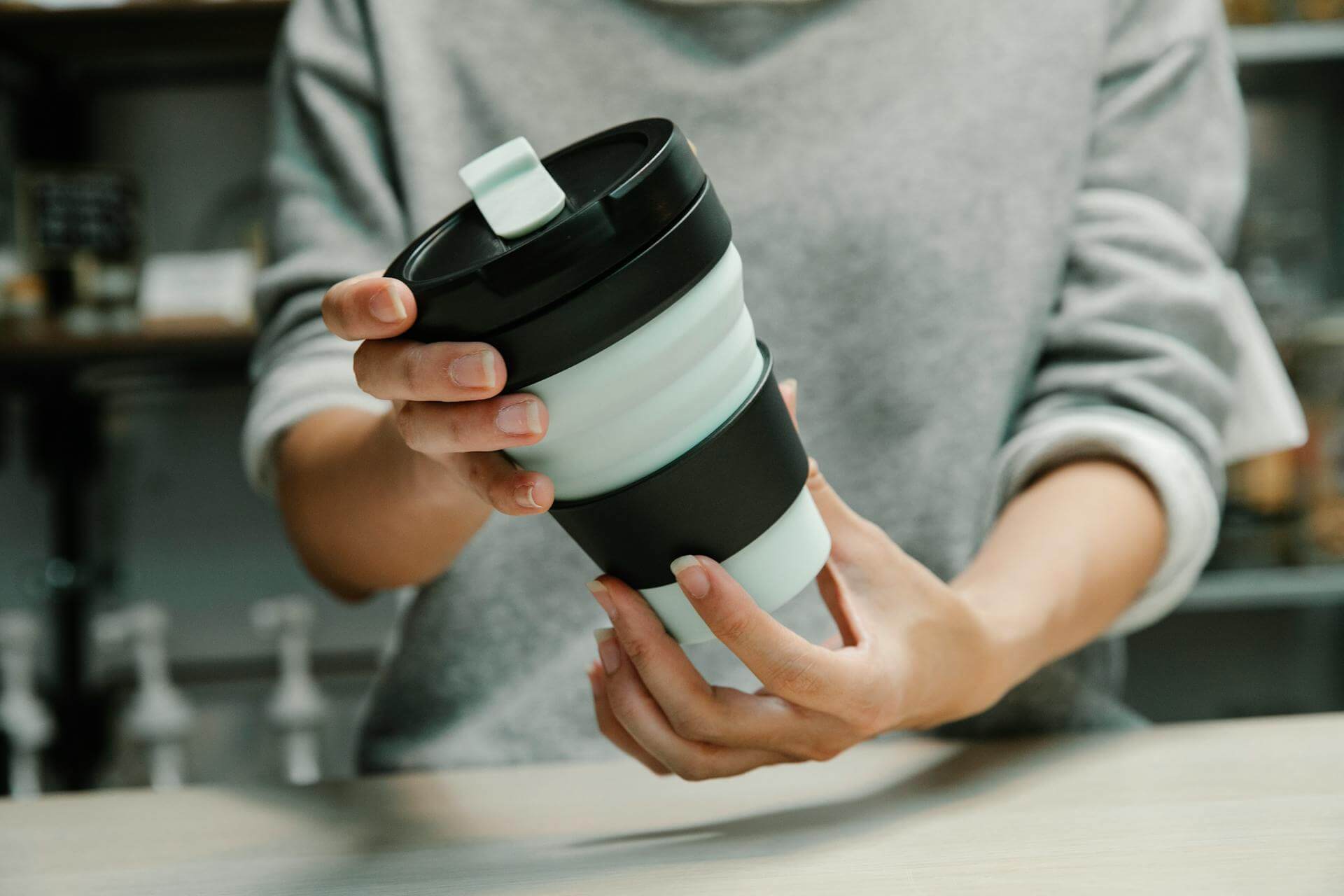 Person Holding Silicon Collapsible Cup