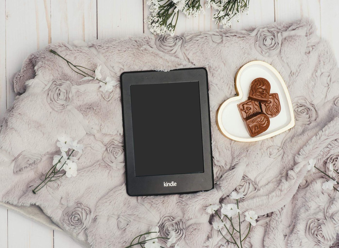 Photo Of Black Kindle Tablet Beside Bowl Of Choclates