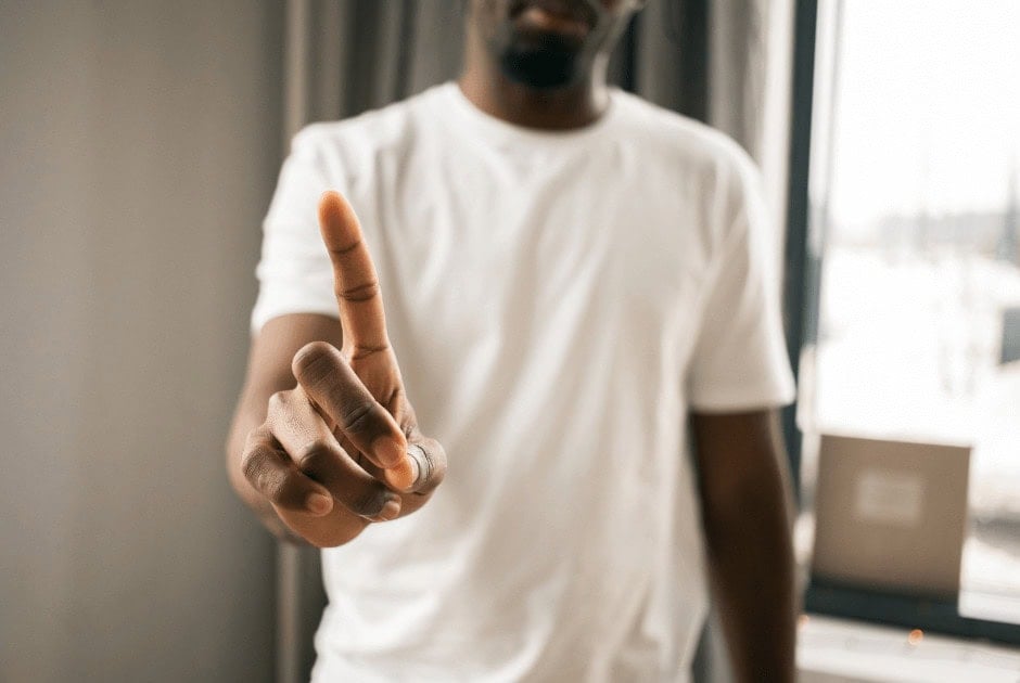 A man telling someone to stop using a finger