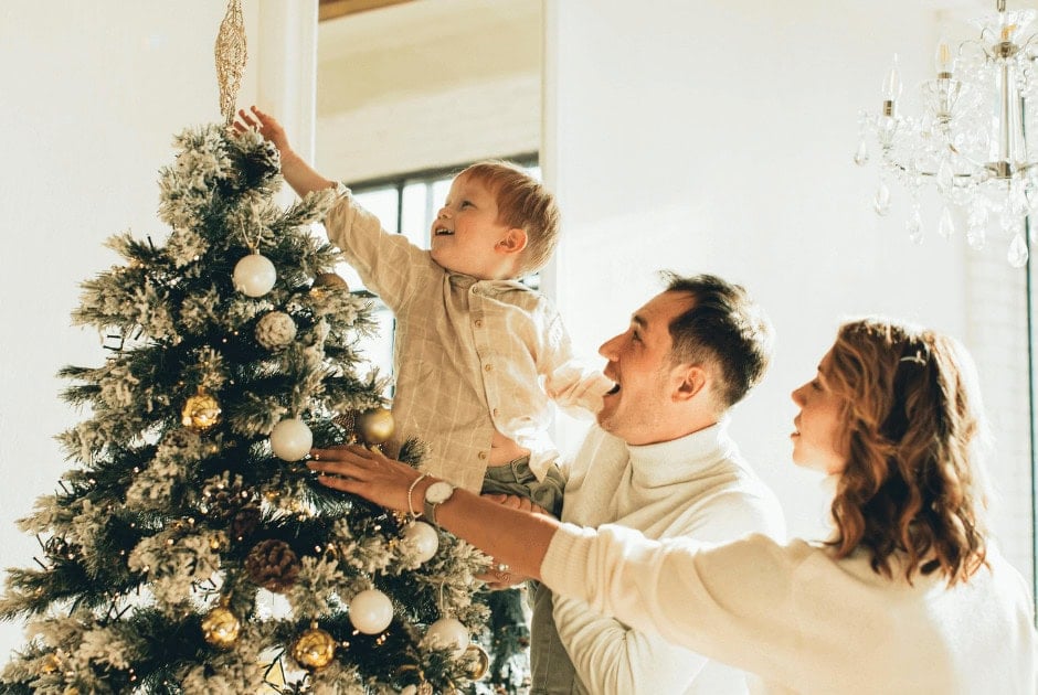 Family Decorating a Christmas Tree - 10 Easy and Affordable Christmas Decor Ideas