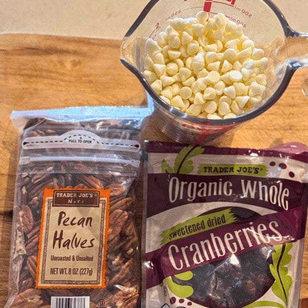 Ingredients for White Chocolate Christmas Bark recipe, white chocolate chips, pecan halves, cranberries