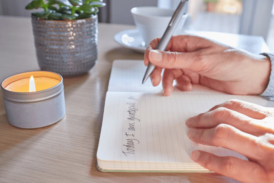 Journalling on a white notebook - 10 Tips to Reduce Stress During the Holiday Season