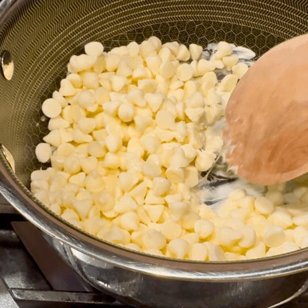 Melting white chocolate on a saucepan