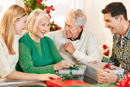 A man handing gifts to his in-laws - What To Buy For The Parents or In-Laws Who Have Everything
