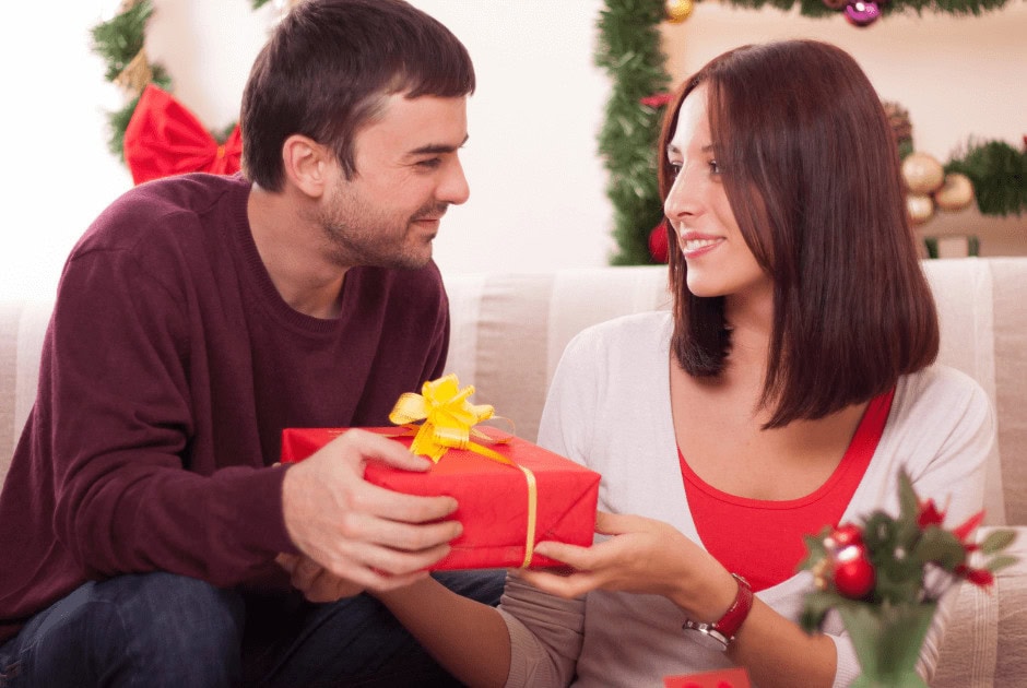 A man receiving a gift in a red box - What To Buy For The Man Who Has Everything