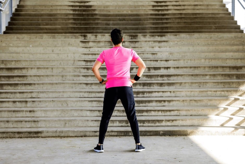 A man standing with his back turned - 10 Realistic New Year’s Resolutions For A Healthier Lifestyle In 2025