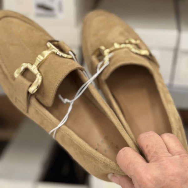 Lori holding a pair of Carolyn Loafers