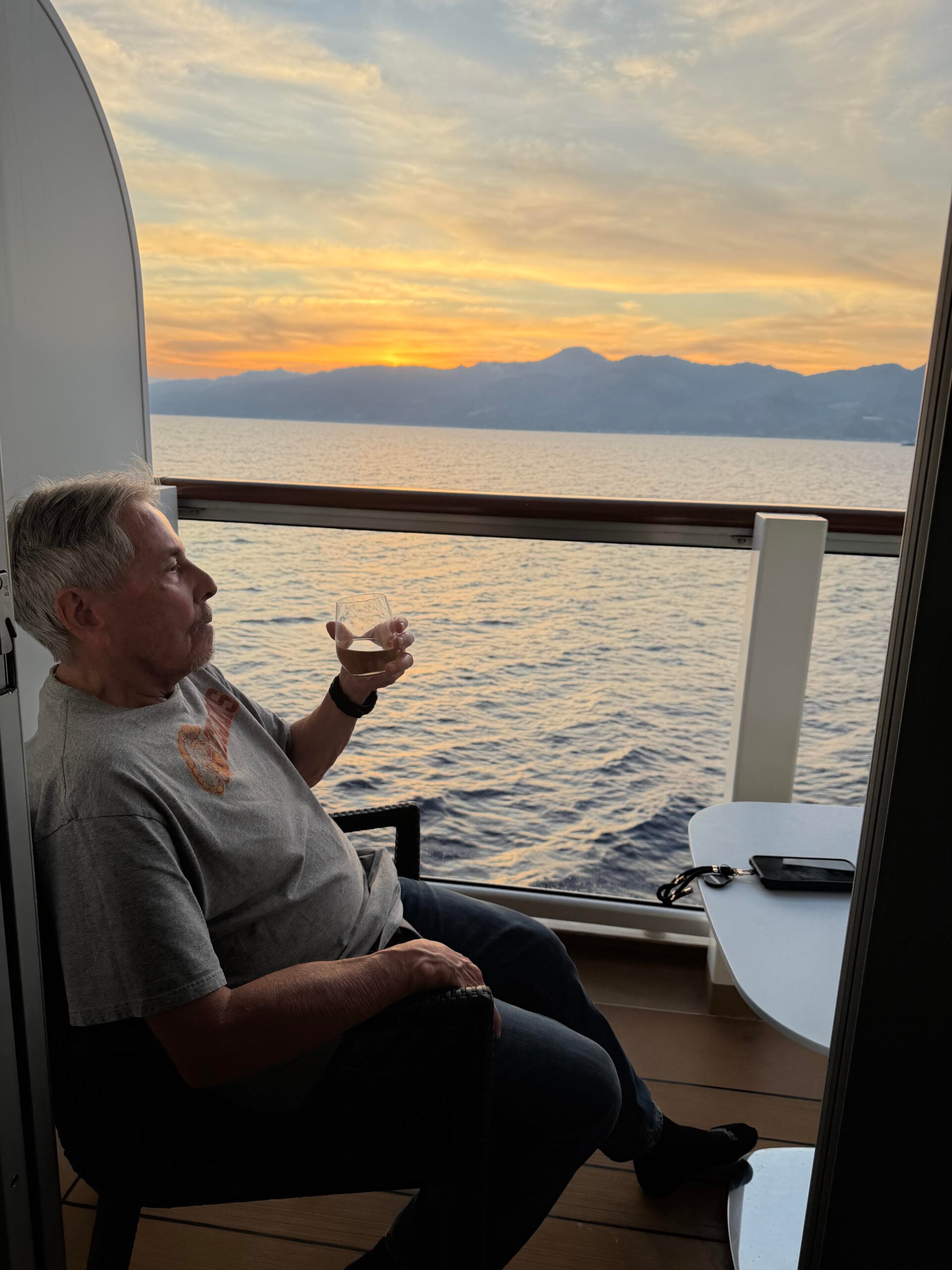 Art Felix enjoying a glass of wine on the balcony of the Viking Neptune